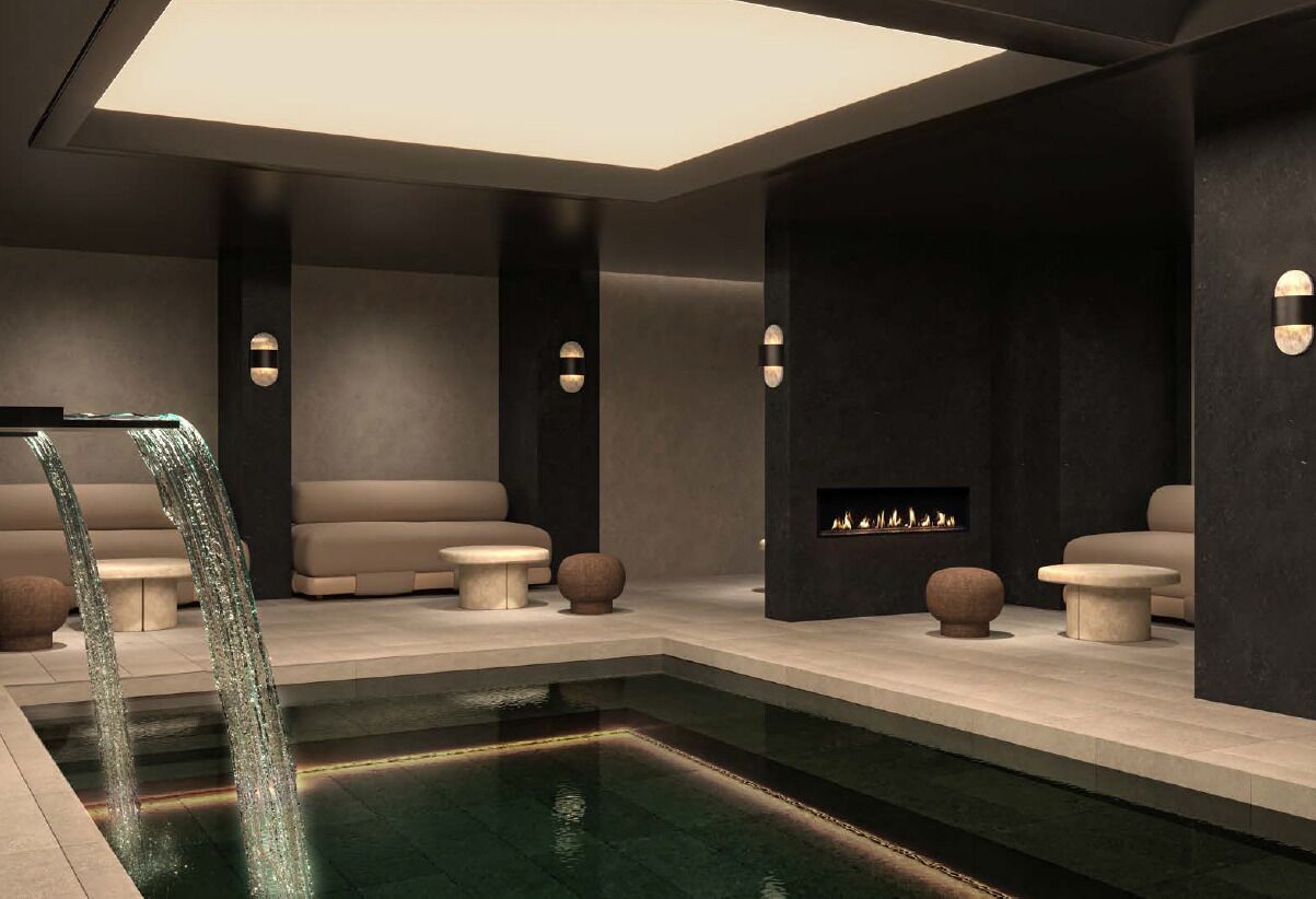 Un área de spa moderna con piscina, asientos y chimenea.