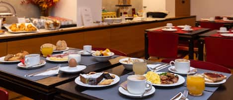 A breakfast buffet with various food items and beverages.