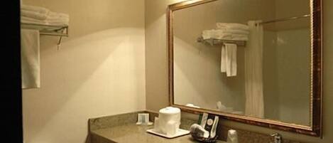 A bathroom with a sink, mirror, and towel rack.