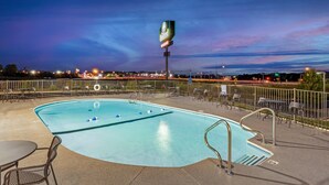 A swimming pool with a lifeguard tower, surrounded by a fence and seating area. - The Bradford Hotel, an Ascend Collection Hotel (Springfield)