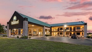 A hotel with a prominent sign, a covered parking area, and a well-lit entrance. - The Bradford Hotel, an Ascend Collection Hotel (Springfield)