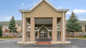 A hotel entrance with a covered walkway, brick pillars, and a central entrance. - Country Inn & Suites by Radisson, Green Bay, WI (Green Bay)
