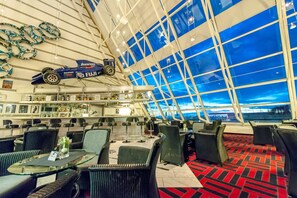 Relax in our spacious lounge area with a high ceiling and comfortable seating options.