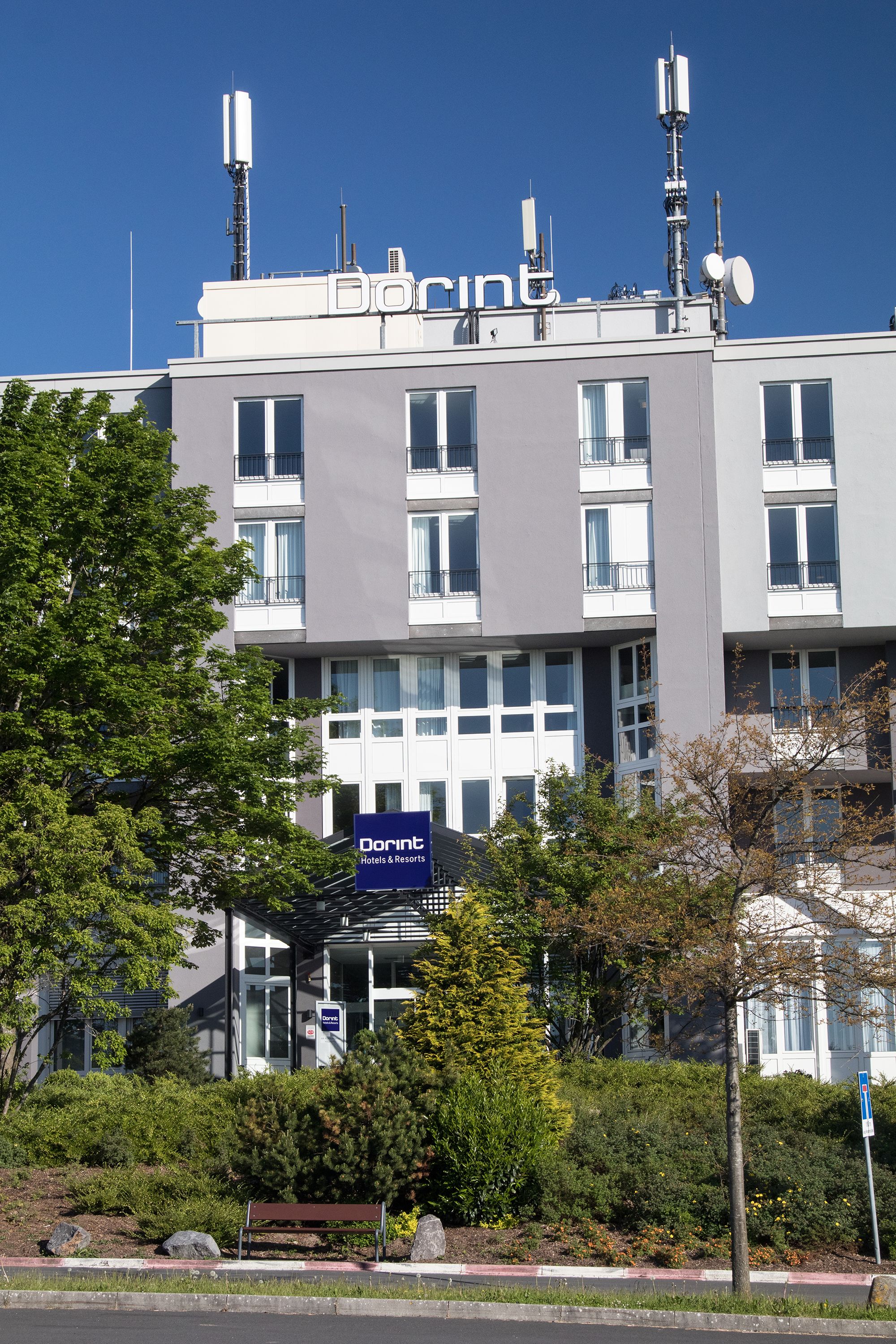 A Dorint hotel building with a modern facade, multiple windows, and a sign indicating it is a Dorint hotel.