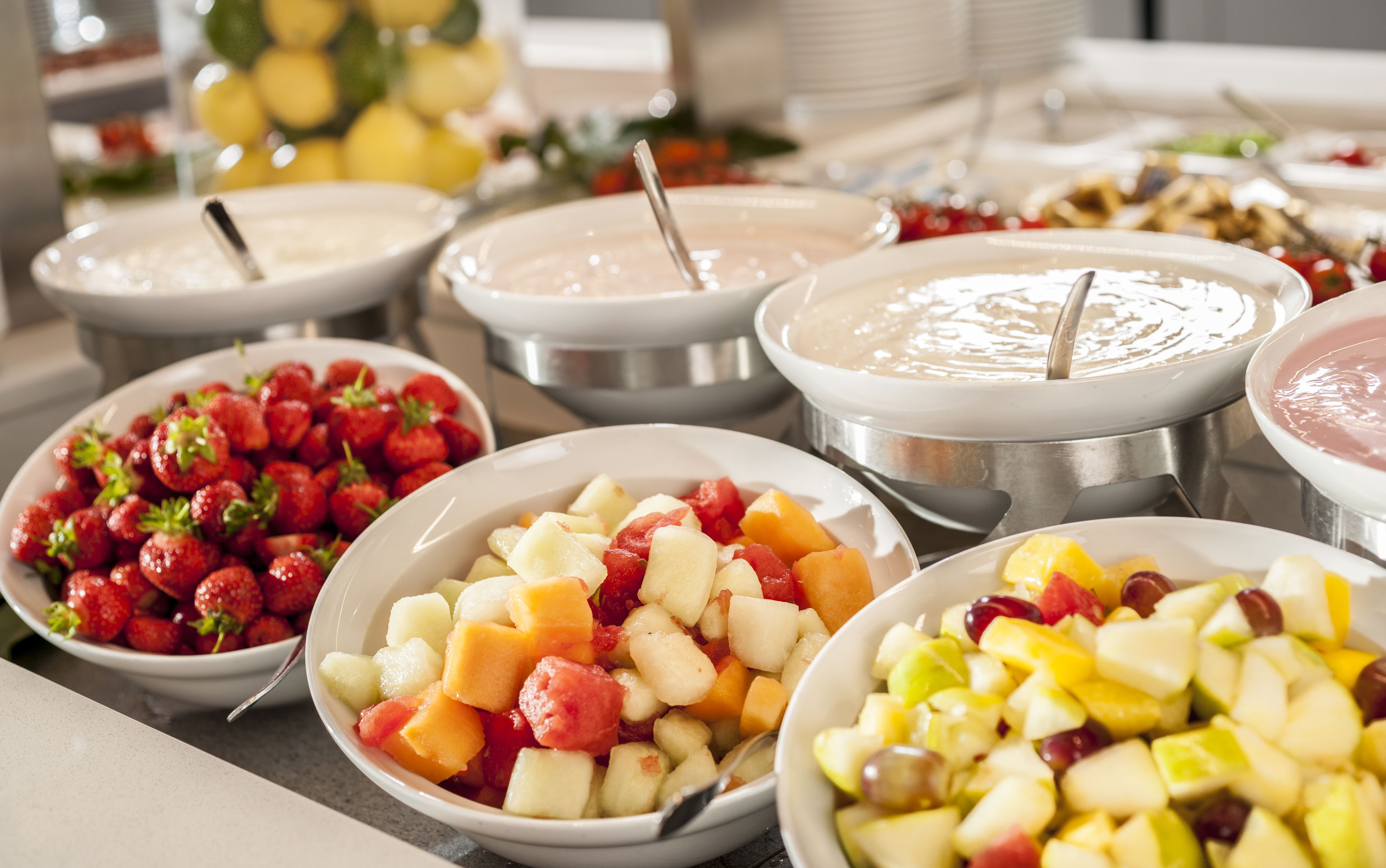 A buffet with various fruit and dessert options.