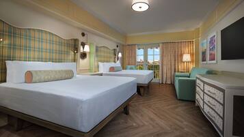 A hotel room with two beds, a sofa, a dresser, and a view of the outdoors.