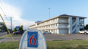 A motel with a sign indicating room number 6.