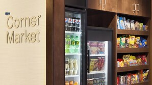 A corner market with a refrigerated display case and shelves stocked with snacks and beverages. - Fairfield Inn & Suites Colorado Springs Air Force Academy (Colorado Springs)