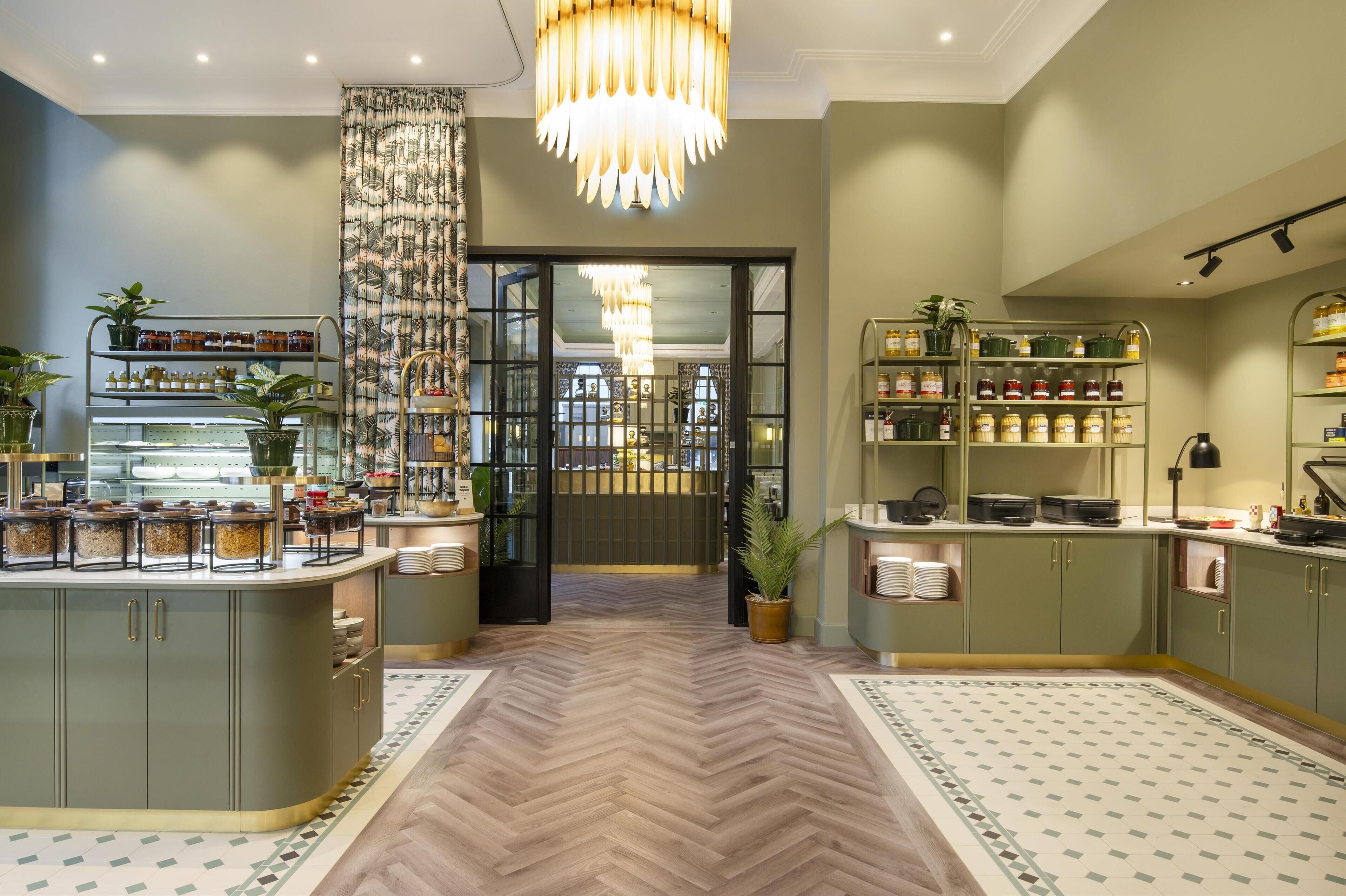 A modern kitchen with a herringbone floor, open shelving with jars, and a central island.
