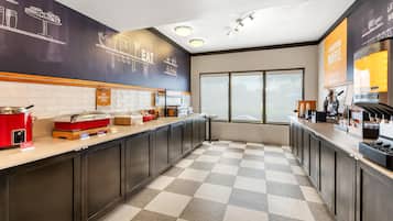 A modern kitchen with a checkered floor, a coffee machine, and a breakfast bar.