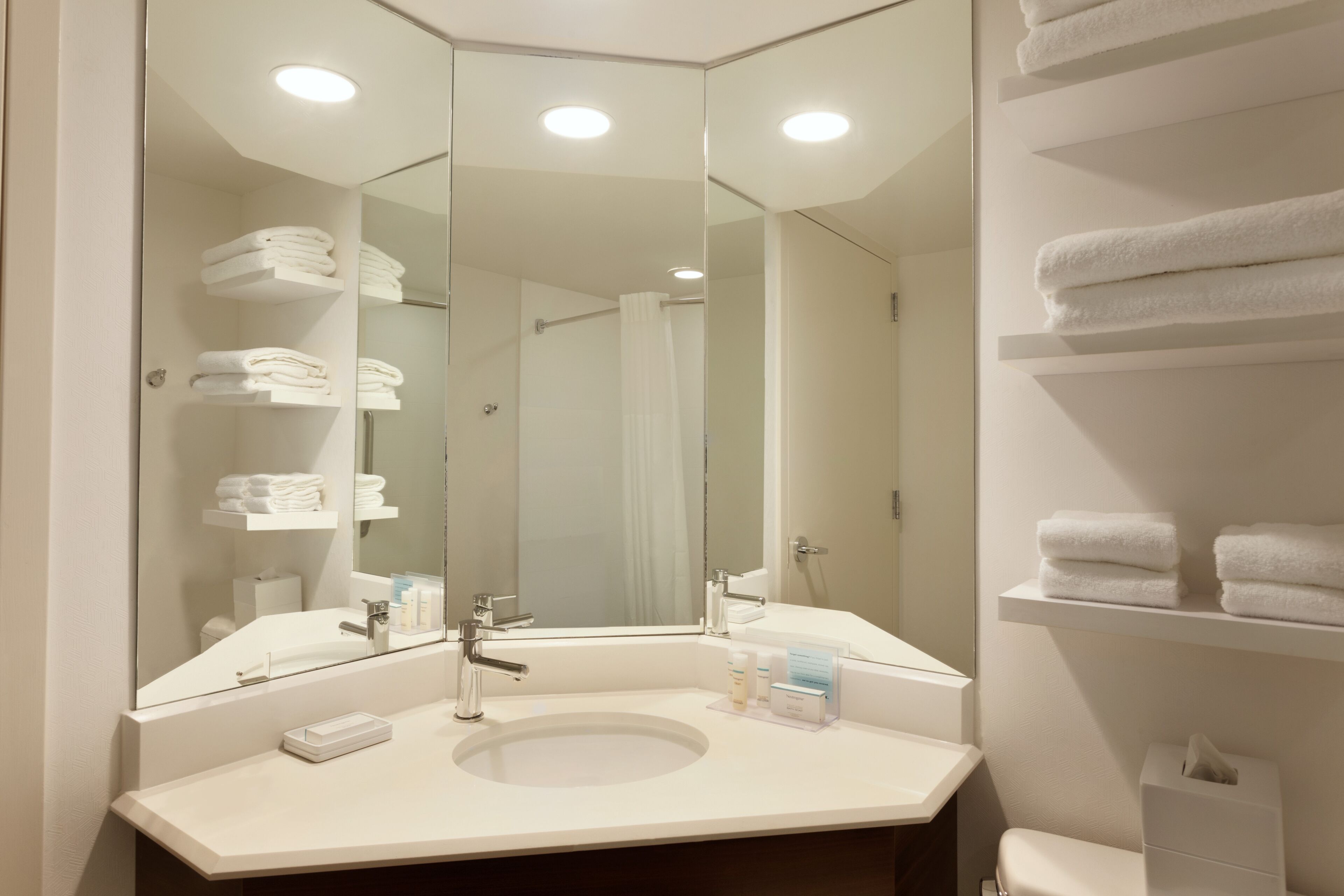 designer toiletries, hair dryer, towels