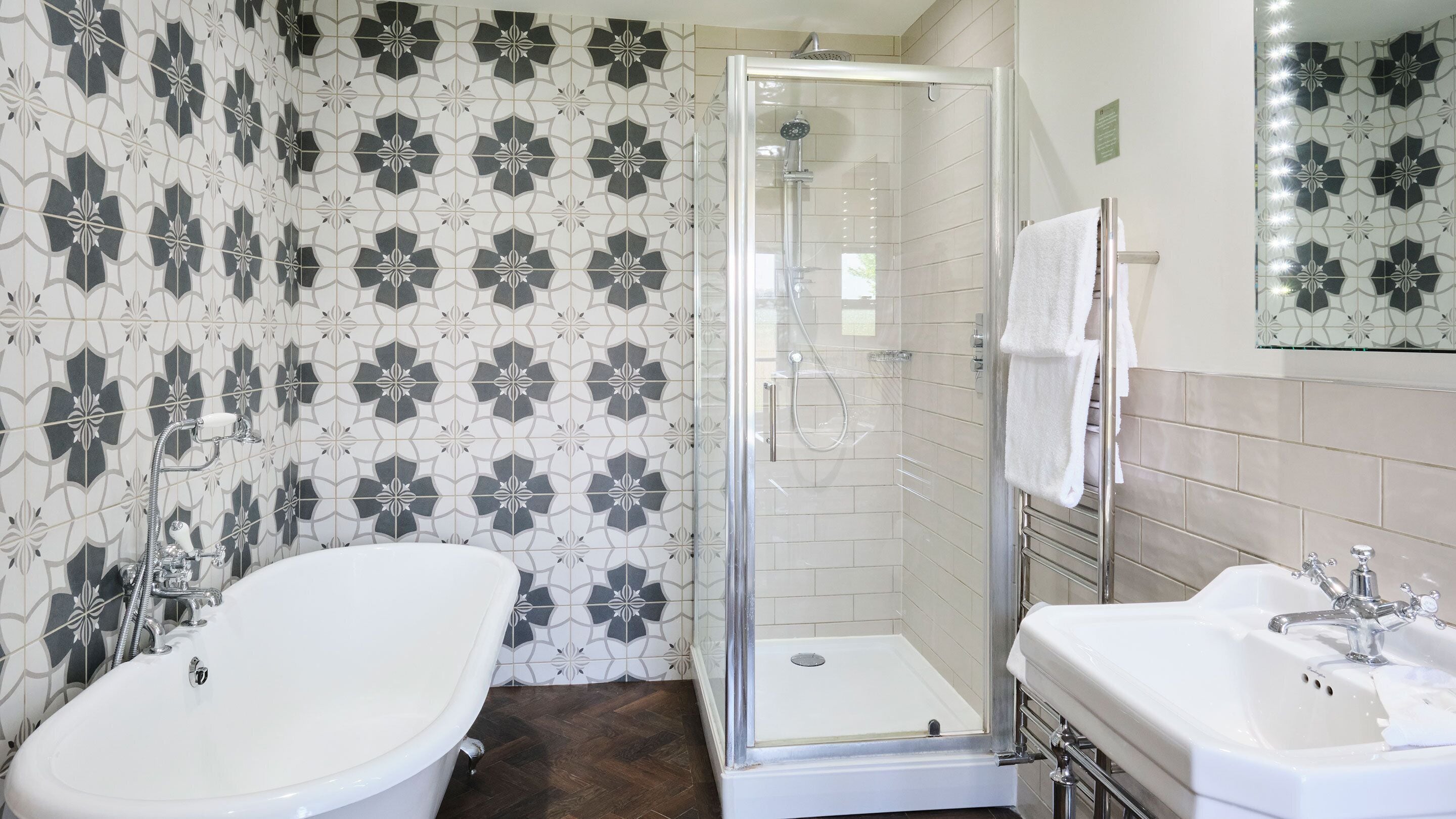 A bathroom with a shower, a bathtub, and a sink.