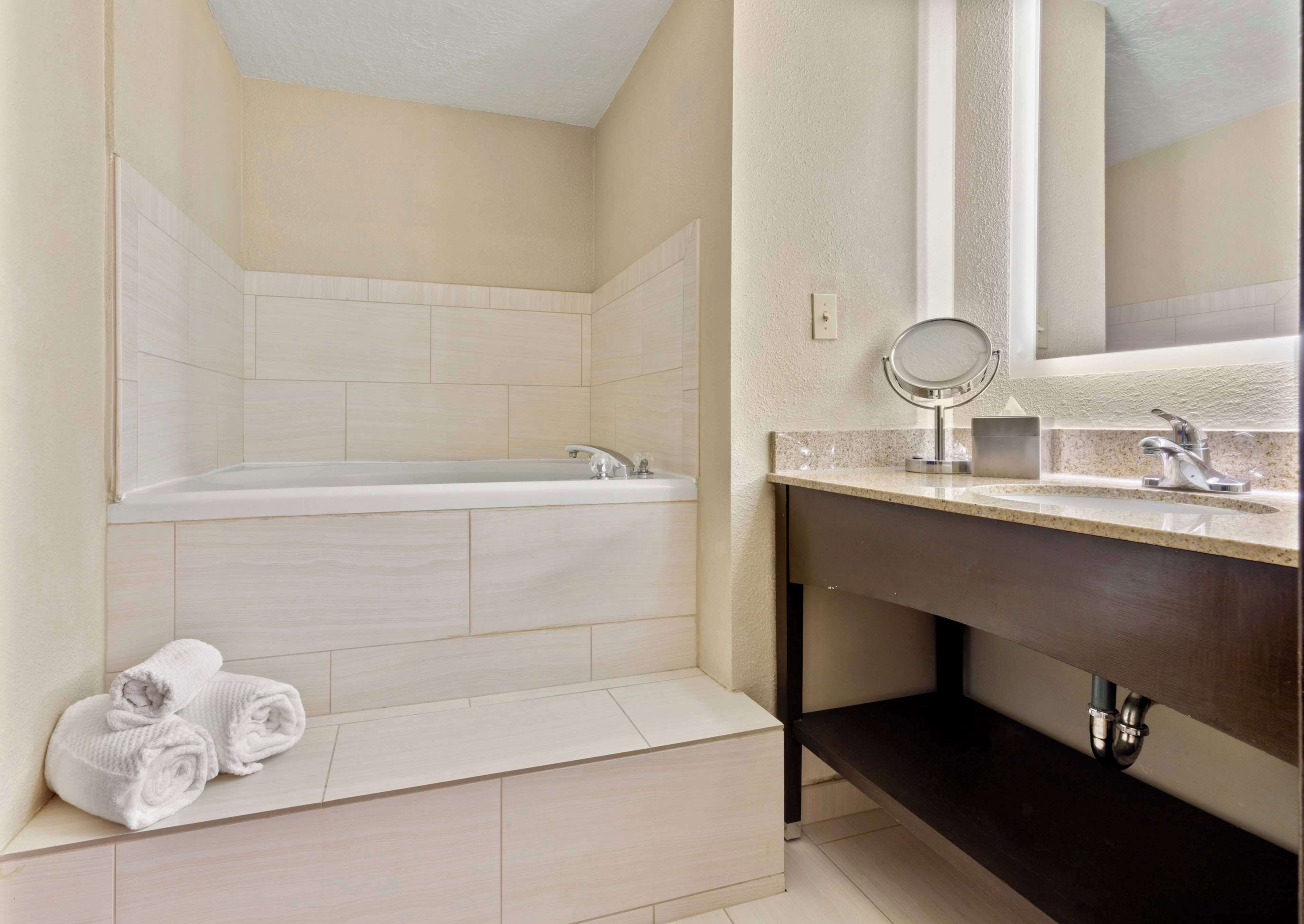 suite, 1 king bed, non smoking | bathroom | designer toiletries, hair dryer, towels, soap