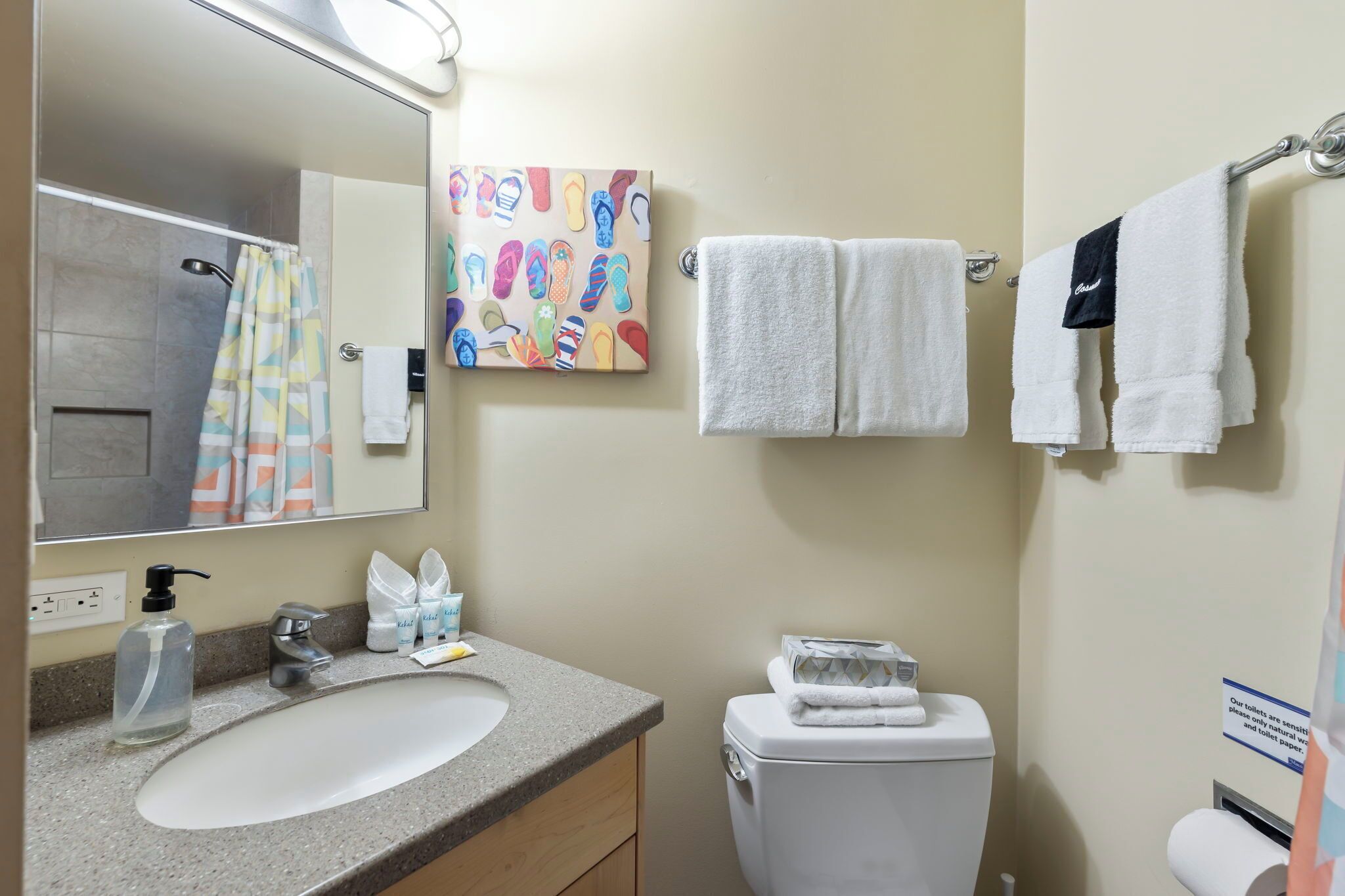 A bathroom with a sink, mirror, towel rack, and toilet.