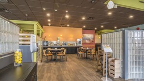 A restaurant interior with a counter, seating area, and decorative elements.