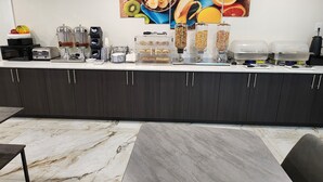 A modern kitchen with a marble countertop, a coffee machine, a toaster, and a fruit bowl. - Serenity Stay (Chattanooga)