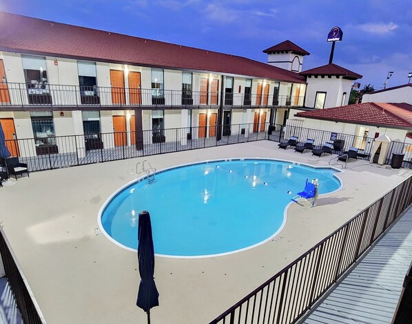 Seasonal outdoor pool, open 9:00 AM to 10:00 PM, pool umbrellas