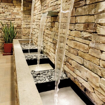 A stone wall with a water feature.