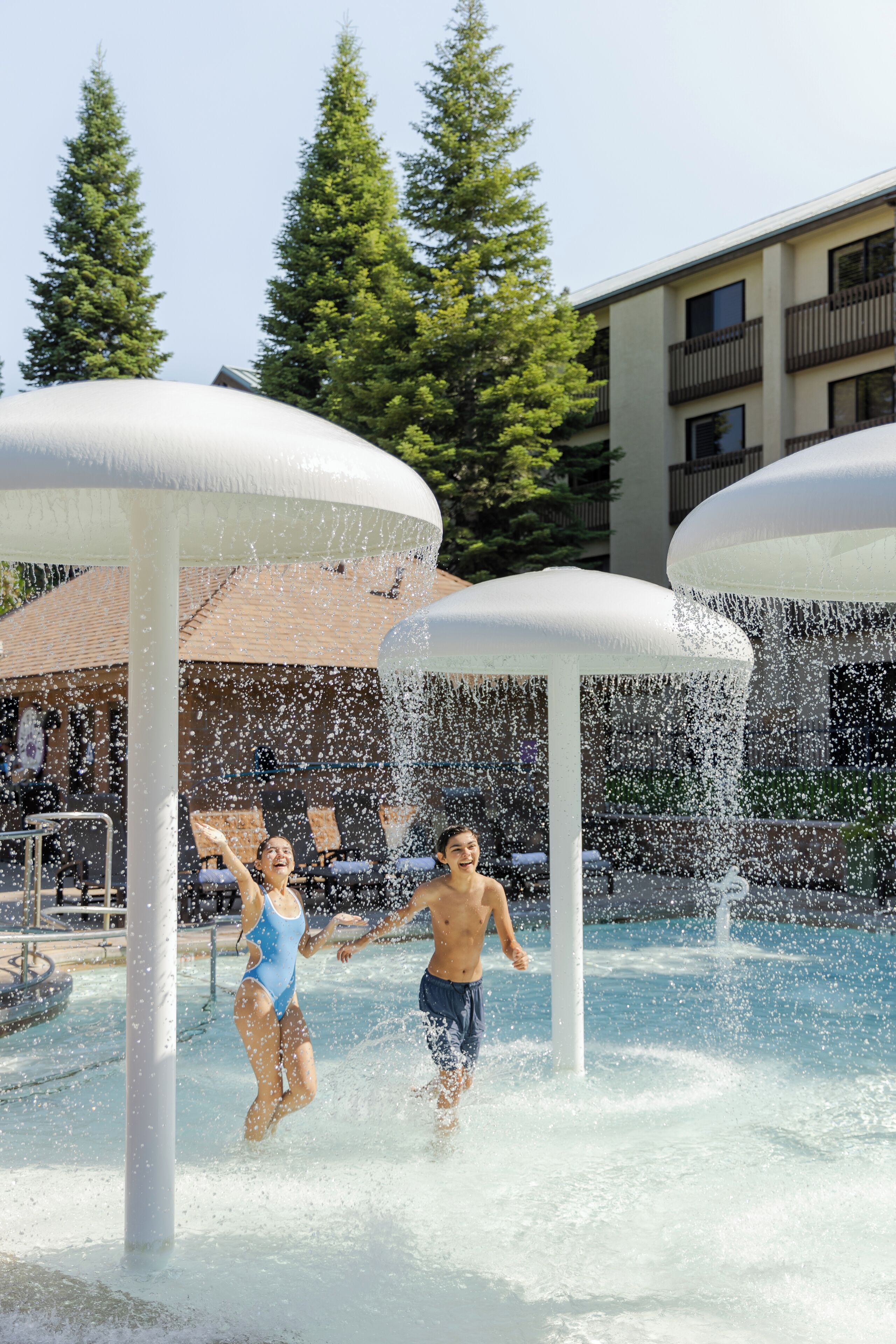 A water play area with multiple water jets and a pool.