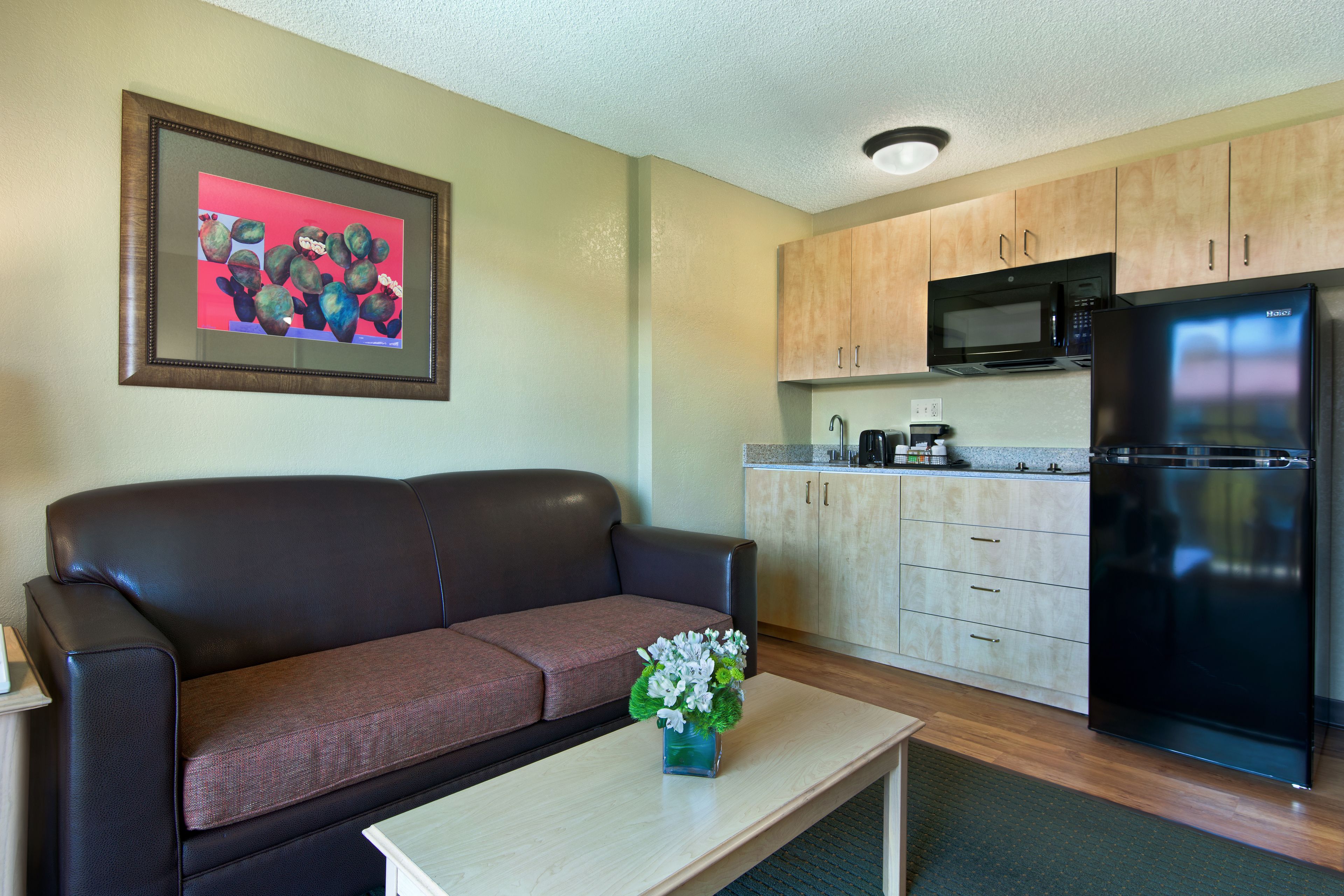 balcony extended stay queen suite kitchenette | living area | flat-screen tv