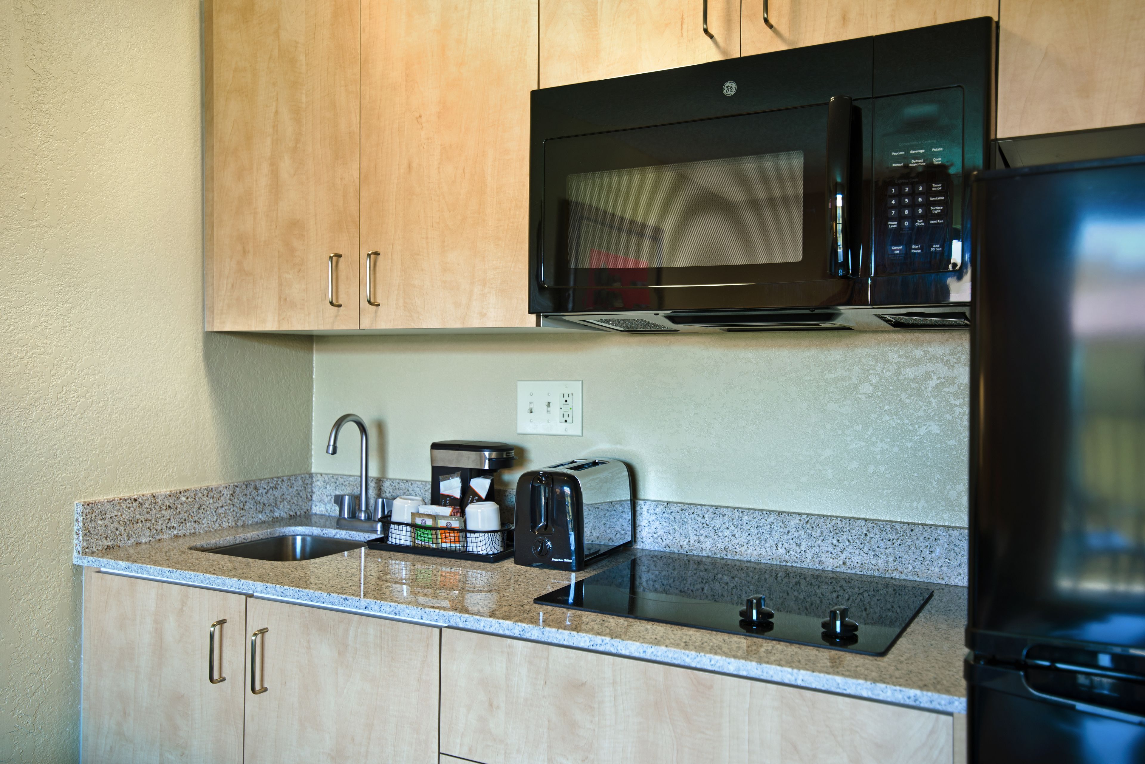 balcony extended stay queen suite kitchenette | private kitchen | mini-fridge, coffee/tea maker