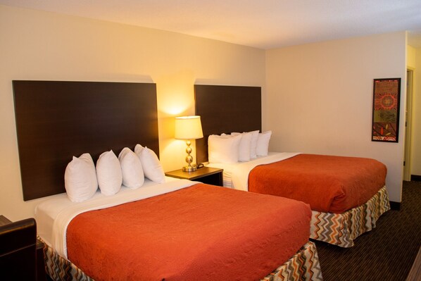 Value Double Queen Room | Premium bedding, pillow-top beds, desk, blackout curtains