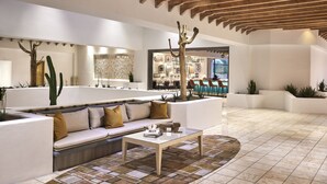 A modern interior with a white sofa, a coffee table, and a wooden ceiling. - Omni Tucson National Resort & Spa (Tucson)