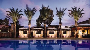 A poolside area with palm trees, outdoor seating, and a bar. - Omni Tucson National Resort & Spa (Tucson)