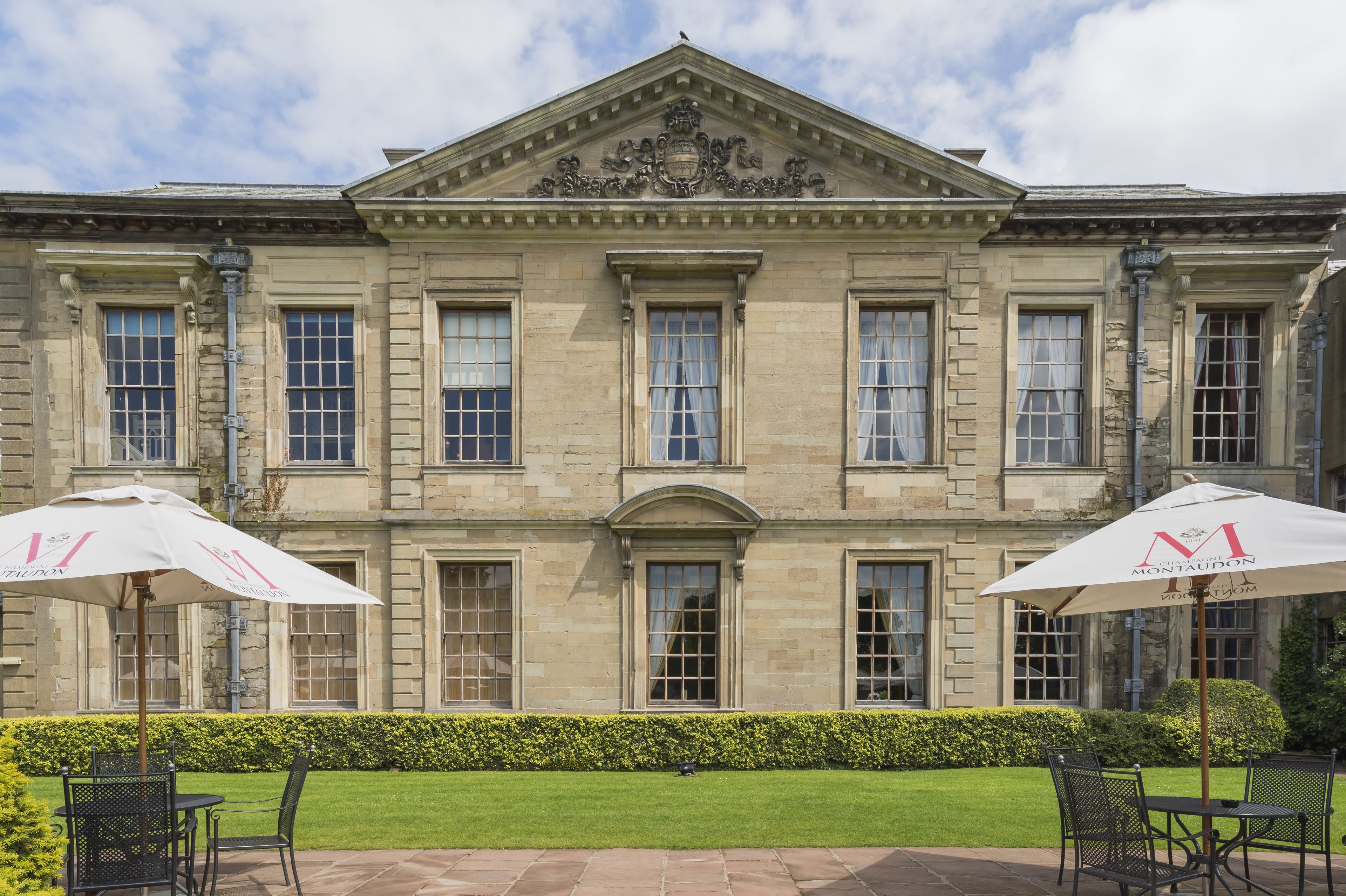A historic building with a symmetrical facade, large windows, and a central entrance.