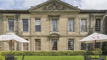 A historic building with a symmetrical facade, large windows, and a central entrance.