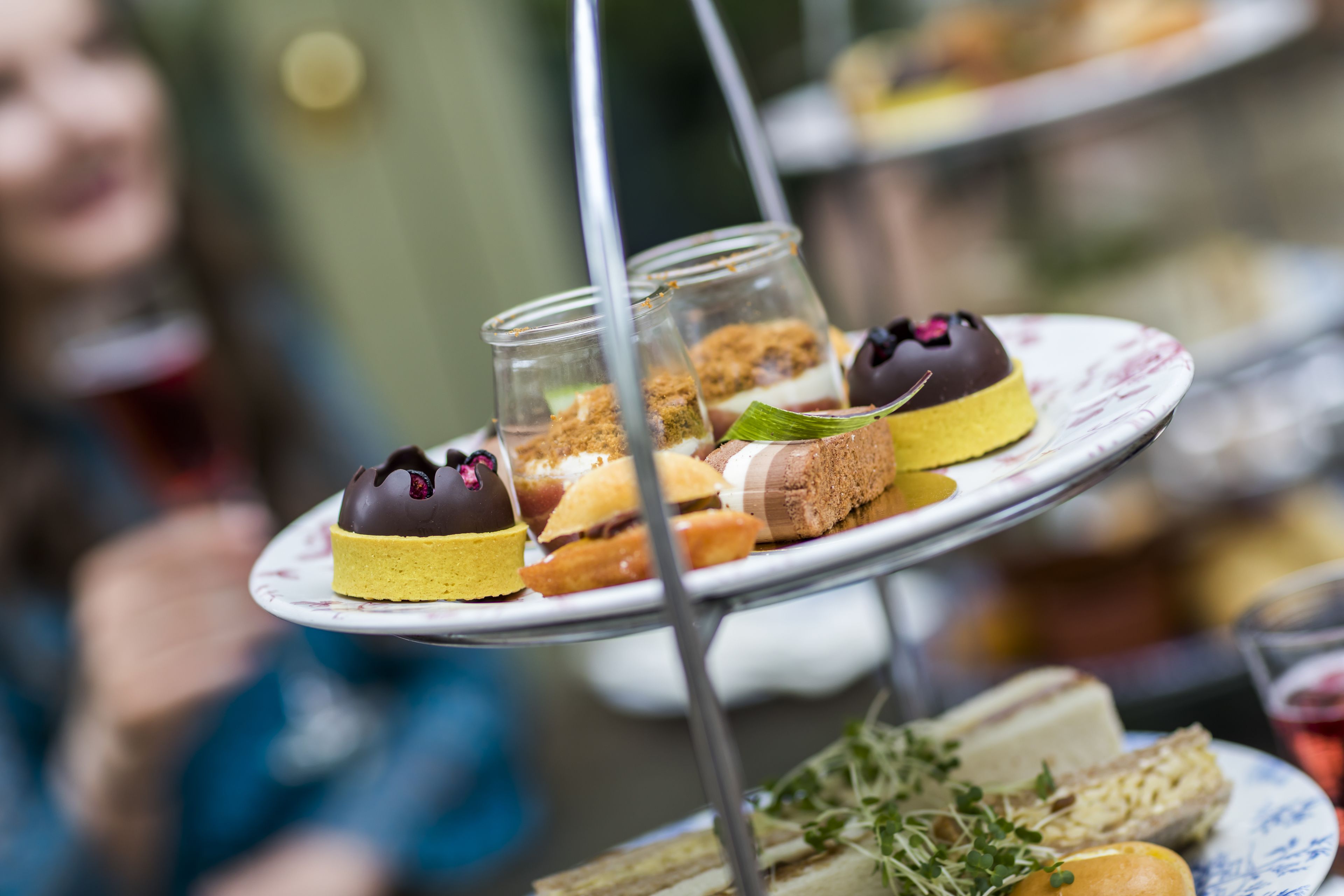 A dessert display with various pastries and desserts on tiered stands.