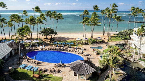 A resort with a swimming pool, beach view, palm trees, and lounge chairs. - The Kahala Hotel & Resort (Honolulu)