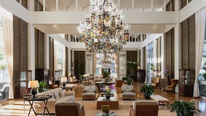 A spacious lobby with a large chandelier, comfortable seating, and large windows. - The Kahala Hotel & Resort (Honolulu)