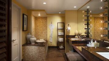 A modern bathroom with a large mirror, multiple sinks, and a vanity area.