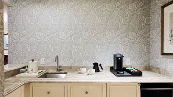 A kitchen with a sink, countertop, and cabinets.