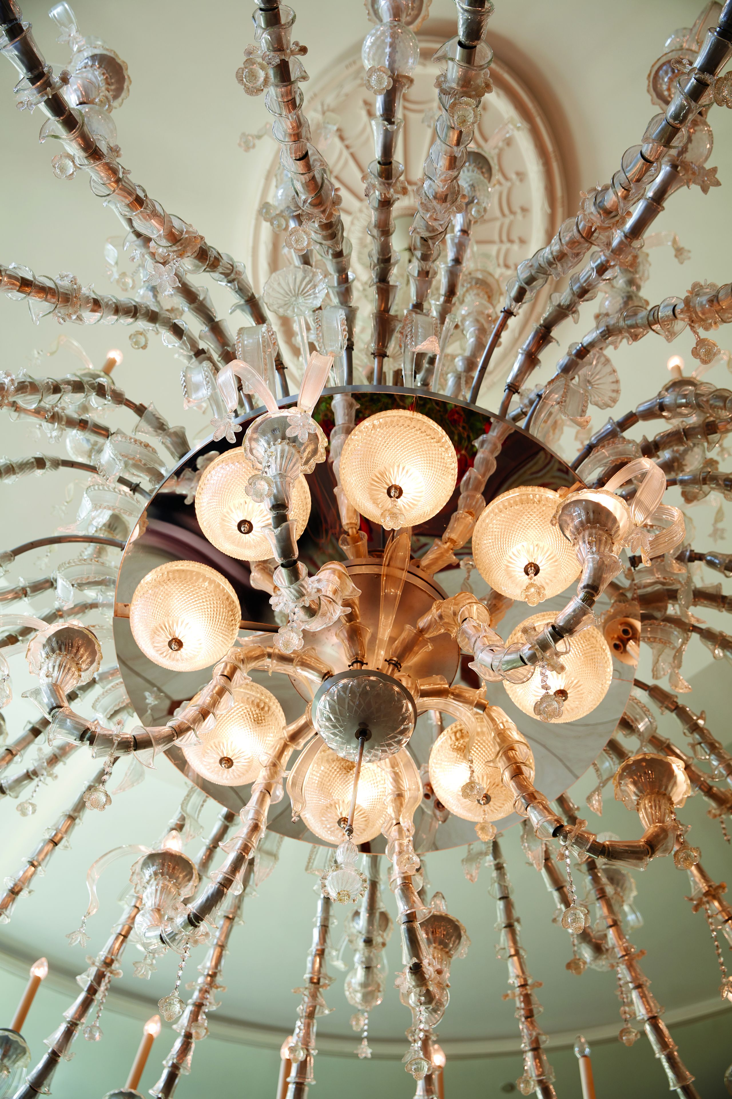 A chandelier with multiple arms and glass elements.