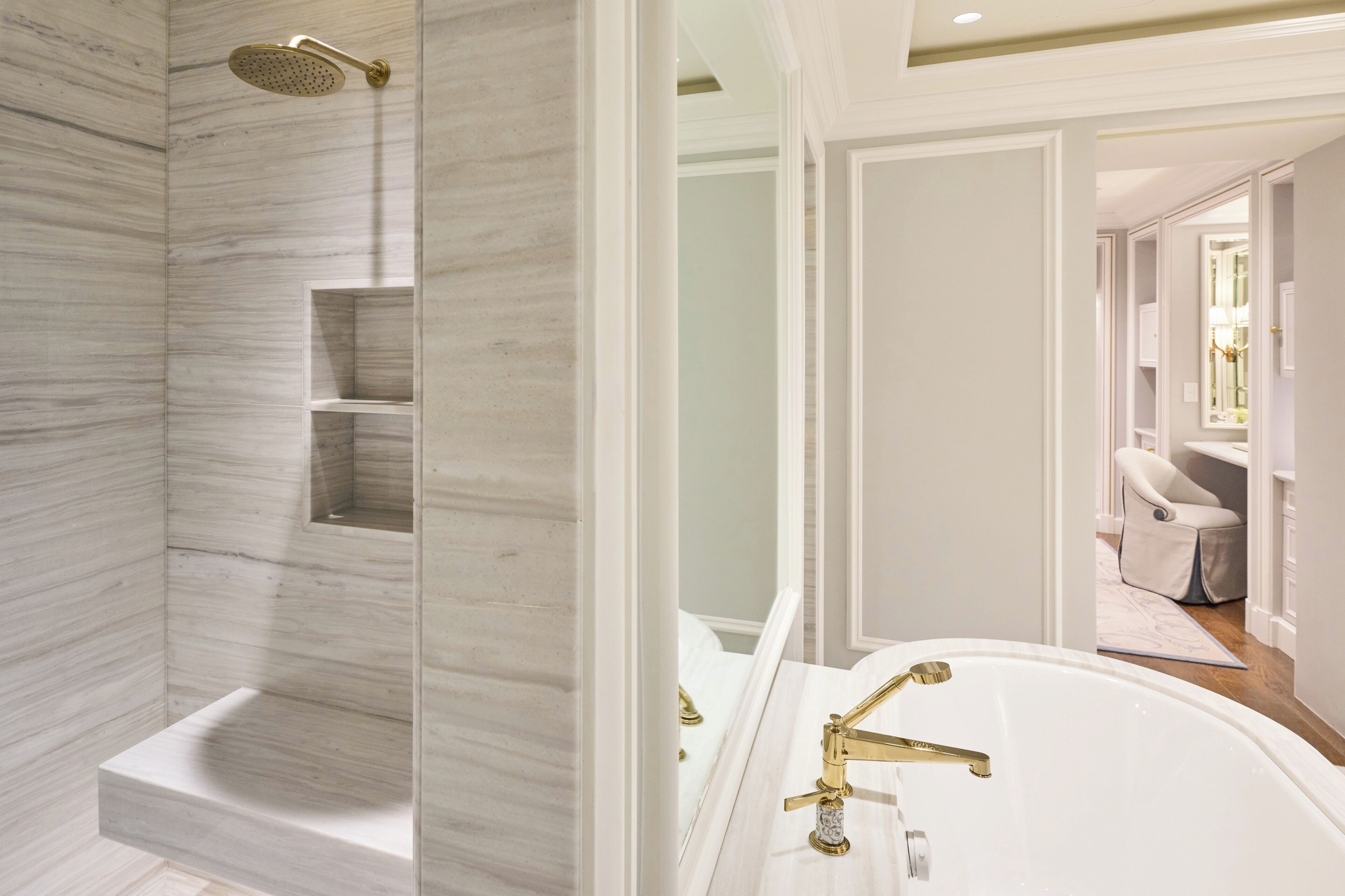 A bathroom with a shower, bathtub, and a vanity with a mirror.