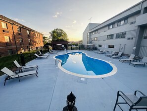 Seasonal outdoor pool, open 10:00 AM to 10:00 PM, pool umbrellas