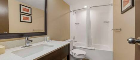 A bathroom with a sink, toilet, and bathtub.
