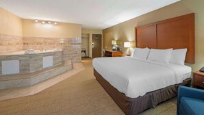 A hotel room with a large bed, a bathroom with a marble vanity, and a desk with a lamp. - Comfort Inn & Suites Indianapolis Northwest - College Park (Indianapolis)