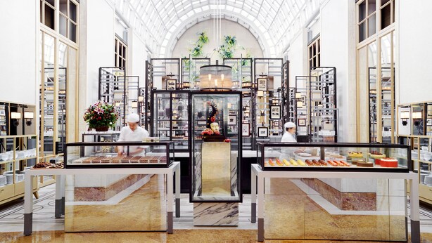 A spacious atrium with a high glass ceiling, featuring a central display of baked goods and a floral arrangement. - The Ritz-Carlton, Millenia Singapore (Singapore)