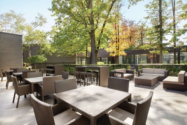 Relax in a serene outdoor space surrounded by lush trees and a beautiful view.