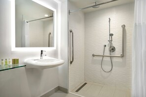 Enjoy a refreshing shower in the bathroom, featuring a glass-enclosed shower with a handheld showerhead and faucet.