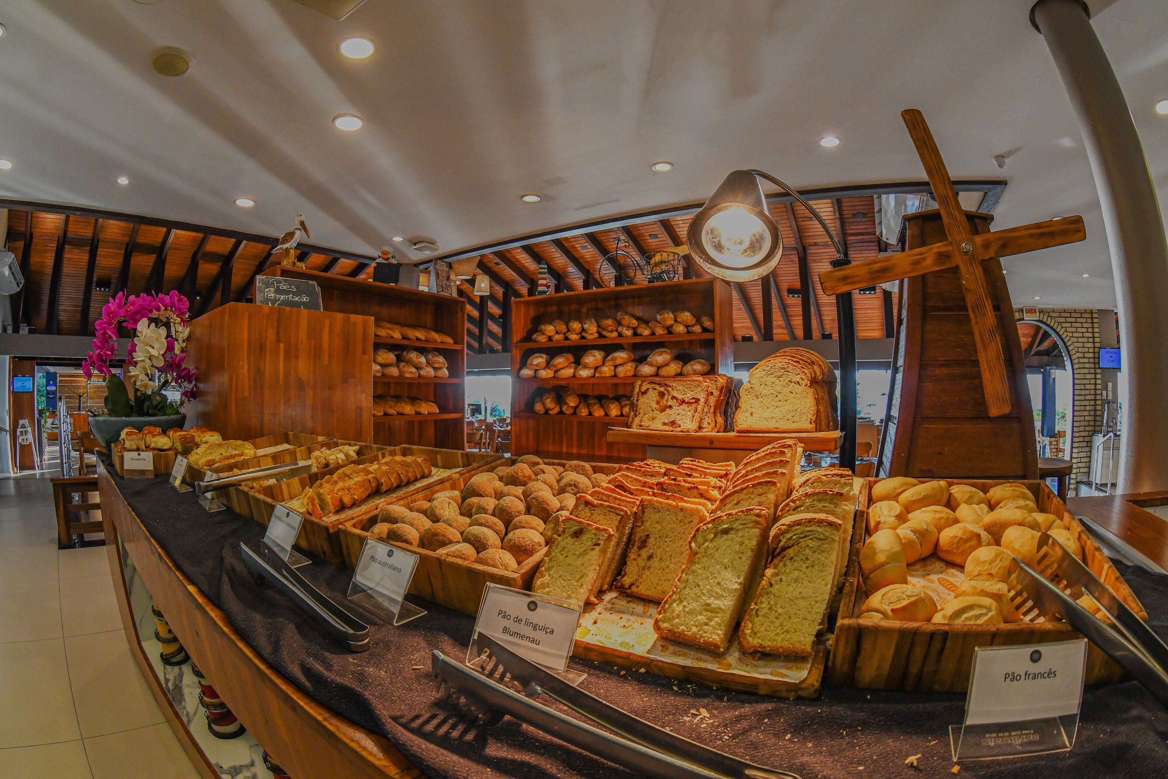 Una vitrina de panadería con panes y pasteles varios.