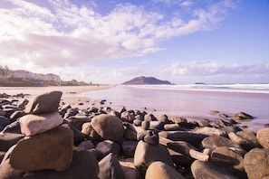 On the beach, white sand, sun-loungers, beach umbrellas