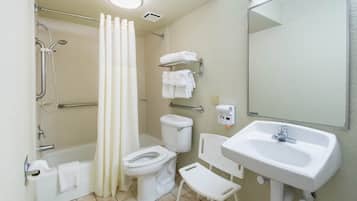 A bathroom with a bathtub, toilet, shower, and sink.