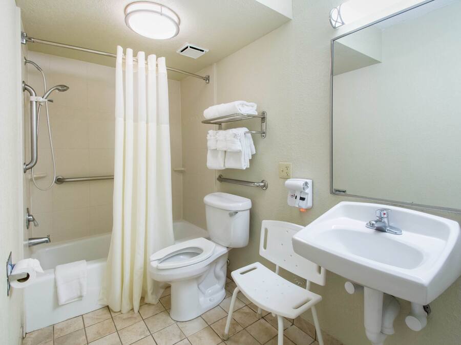 A bathroom with a bathtub, toilet, shower, and sink.