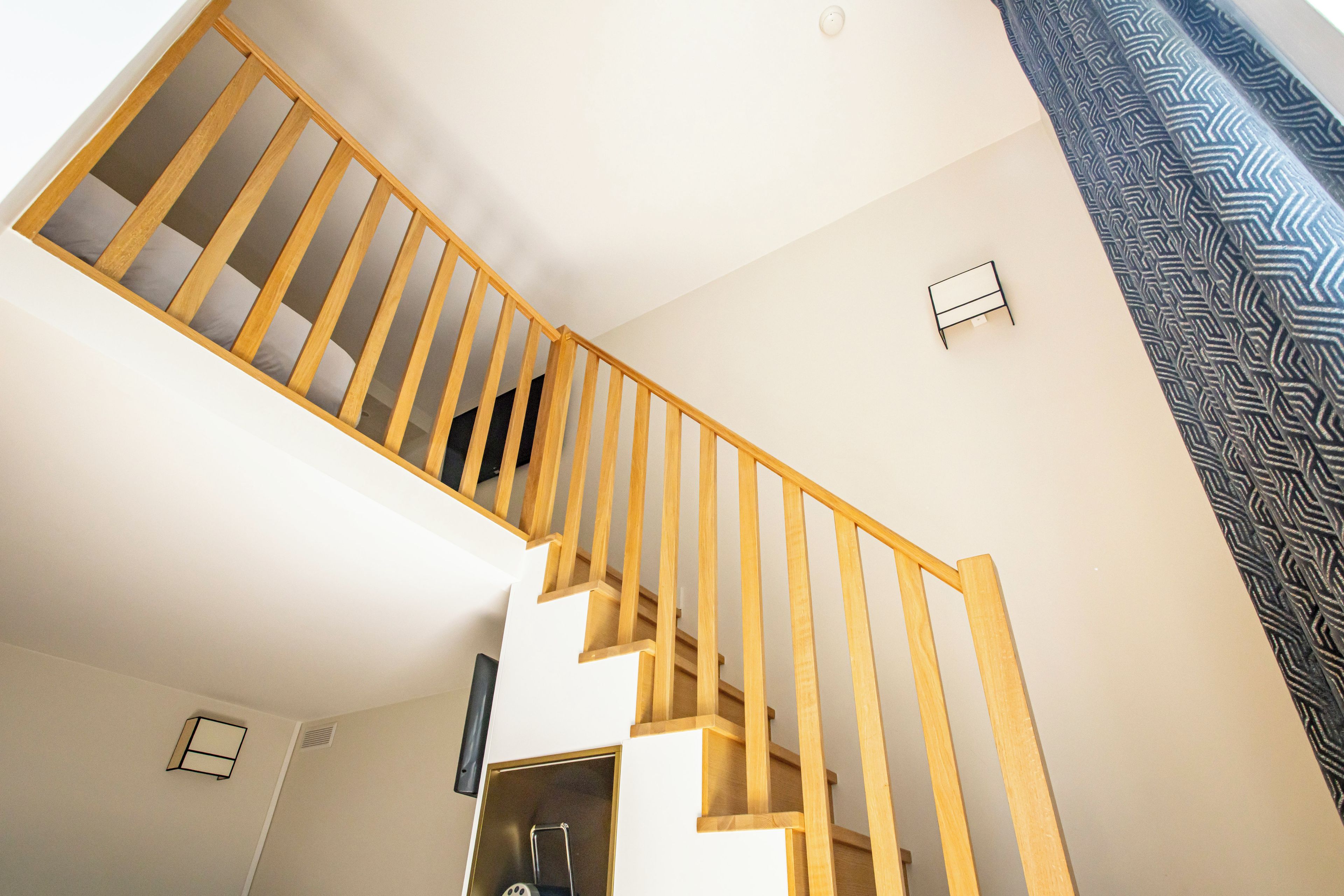 A staircase with wooden railings leading to an upper floor.