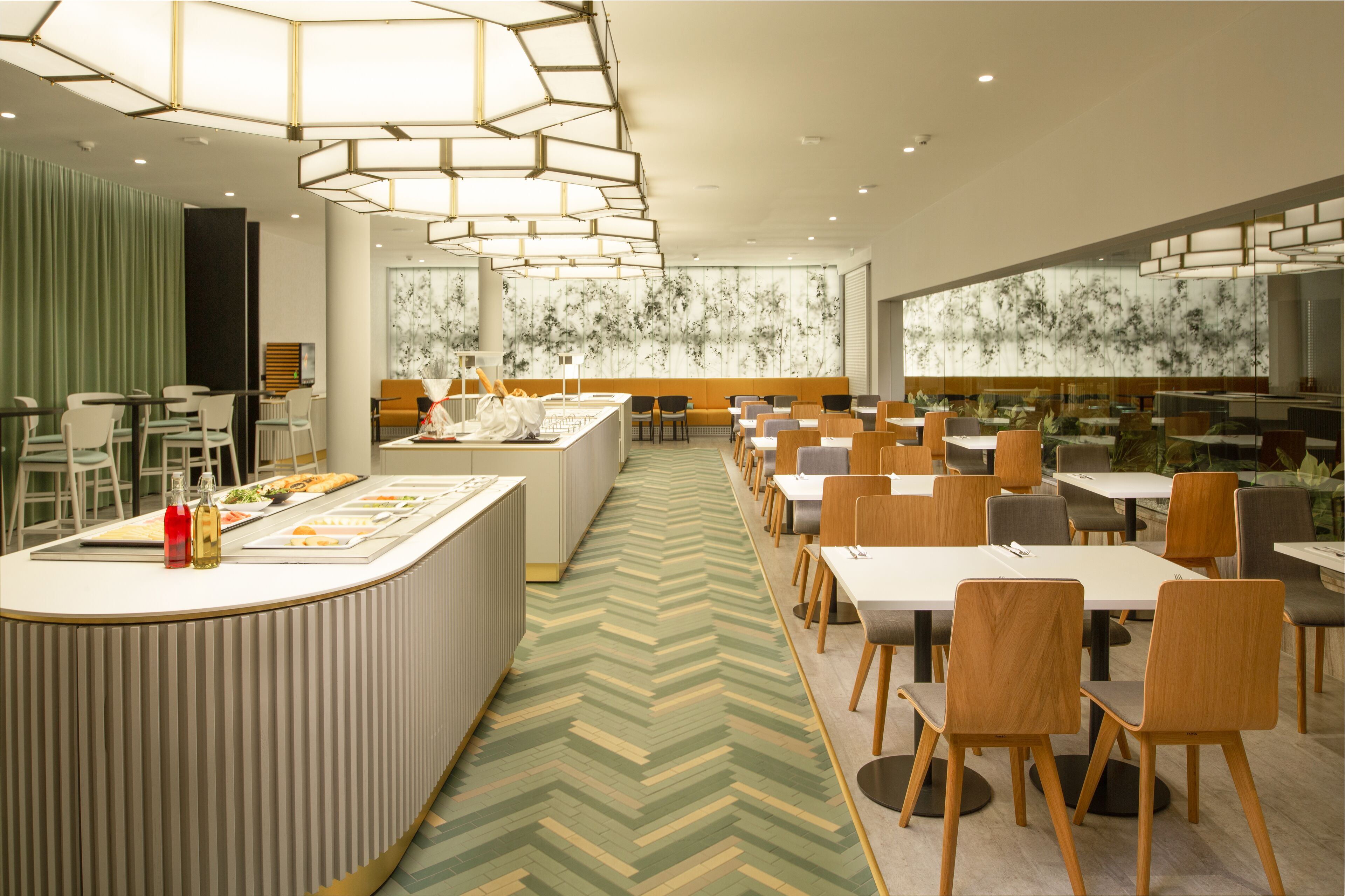 A modern dining area with a central island, multiple tables, and chairs.