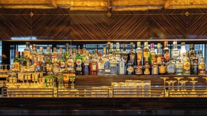 A bar with a variety of liquor bottles and glasses. - Hyllit Hotel (Antwerp)